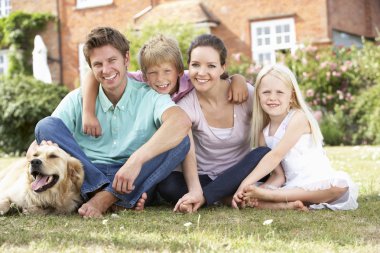 Family Sitting In Garden Together clipart