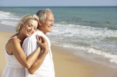 Senior Couple Enjoying Beach Holiday clipart