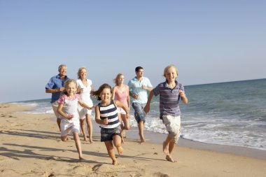 Portrait Of Three Generation Family On Beach Holiday clipart