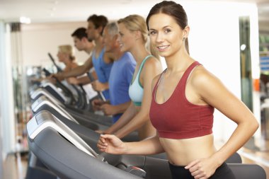 Woman On Running Machine In Gym clipart