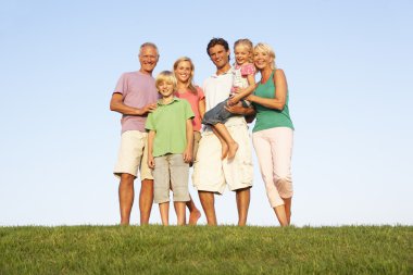 A family, with parents, children and grandparents, posing in a f clipart