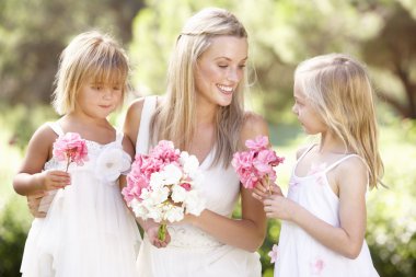 Bride With Bridesmaids Outdoors At Wedding clipart