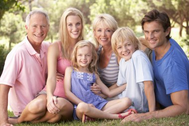 A family, with parents, children and grandparents, relaxing in a clipart