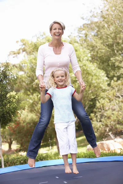 Mutter und Tochter springen auf Trampolin im Garten — Stockfoto