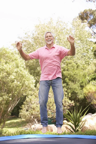 Senior Man Jumping Trampoline Garden — Stock Photo, Image