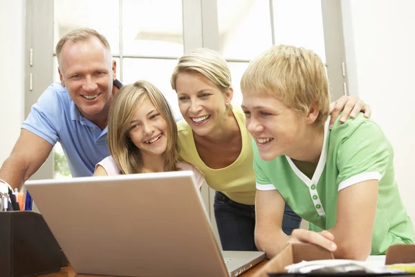 Famille utilisant un ordinateur portable à la maison — Photo