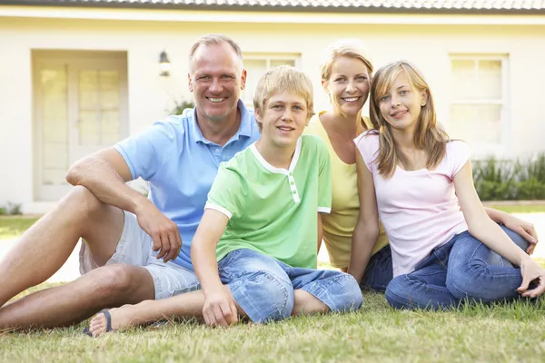 Family Sitting Outside Dream Home — Stock Photo, Image