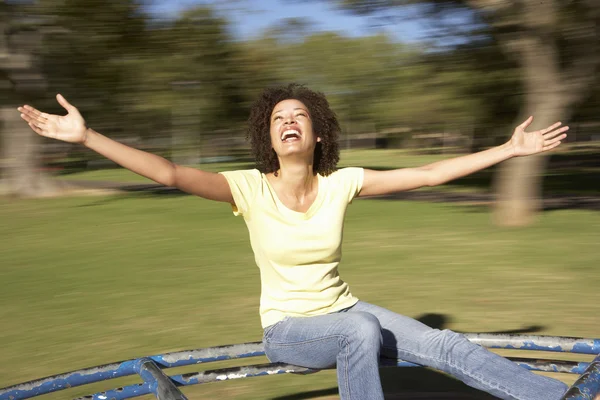 Young Woman Riding On Roundabout In Park — Stock Photo, Image