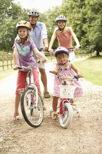 Family Cycling Countryside Wearing Safety Helmets — Stock Photo, Image