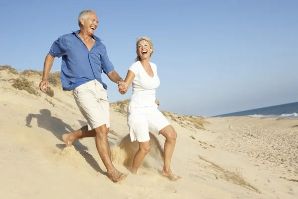 Senior Couple Enjoying Beach Holiday Running Dune — Stock Photo, Image