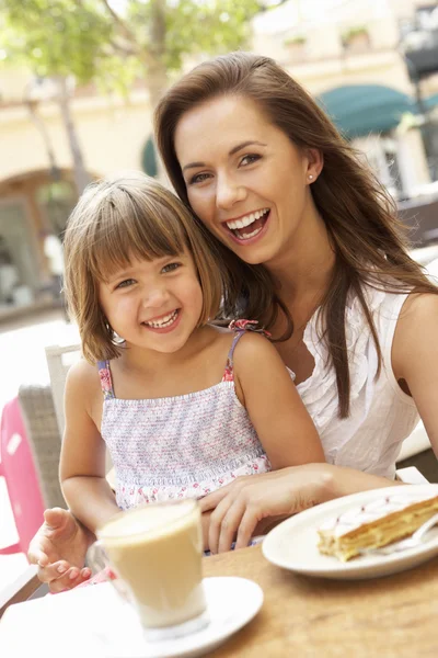 Mother And Daughter Enjoying Cup Of Coffee And Piece Of Cake In — Stock Photo, Image