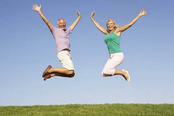 Senior Couple Jumping Air — Stock Photo, Image