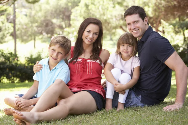 Portrait Of Young Family Relaxing In Park — Stock Photo, Image