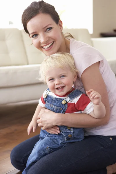 Mother Cuddling Son Home Stock Picture