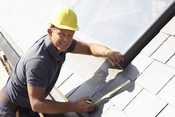 Roofer Working On Exterior Of New Home Royalty Free Stock Images