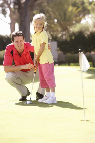 Father Teaching Daughter Play Golf Putting Green Royalty Free Stock Photos