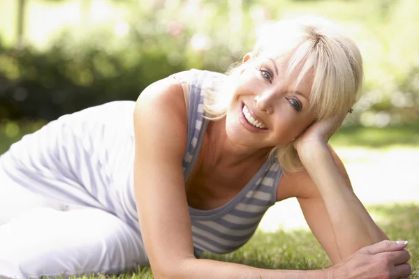Middle age woman posing in park Stock Image