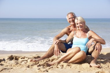 Senior couple on beach holiday clipart