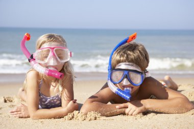 Young children on beach holiday clipart