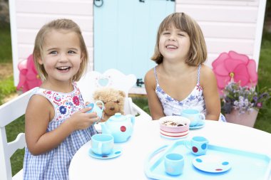 Two young girls play outdoors clipart