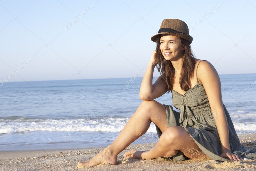 Woman sitting on beach relaxing — Stock Photo © monkeybusiness #5179220