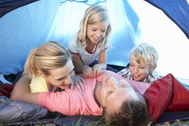 Young family playing in tent clipart