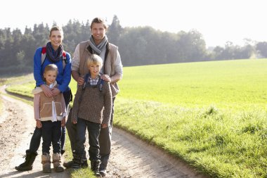 Young family posing in park clipart