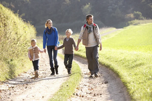 Young family walking in park — Stock Photo, Image