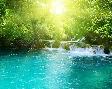 Waterfall in deep forest clipart