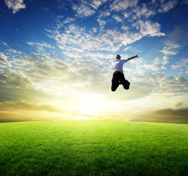 Jumping šťastný mladý muž — Stock fotografie