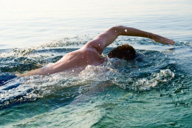 swimming man in clean ocean water clipart