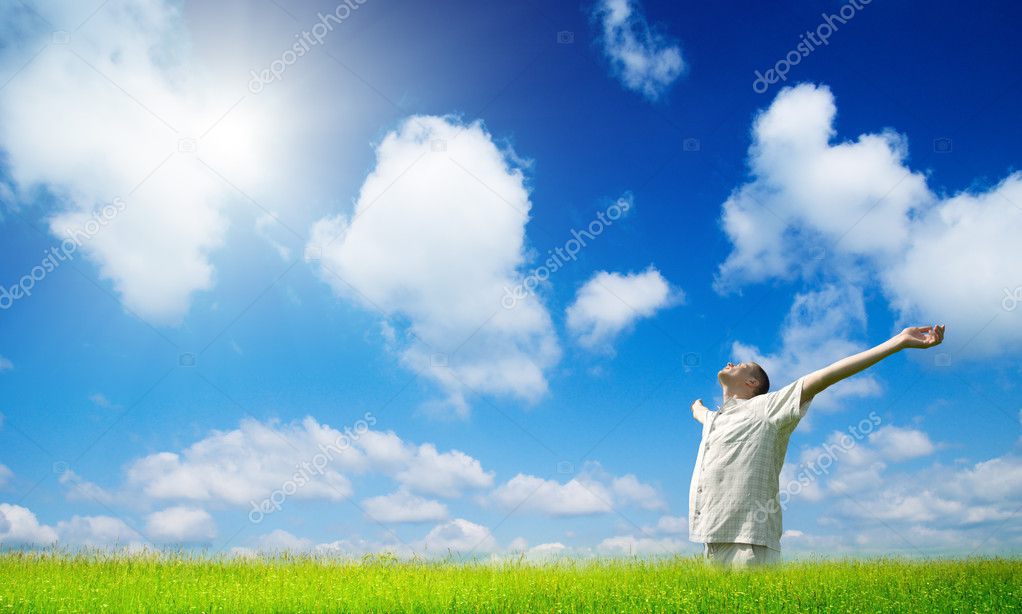 Smiling man taking energy from sun — Stock Photo © Iakov #4607846