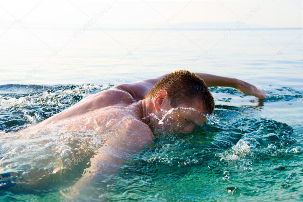 swimming man and clean ocean water