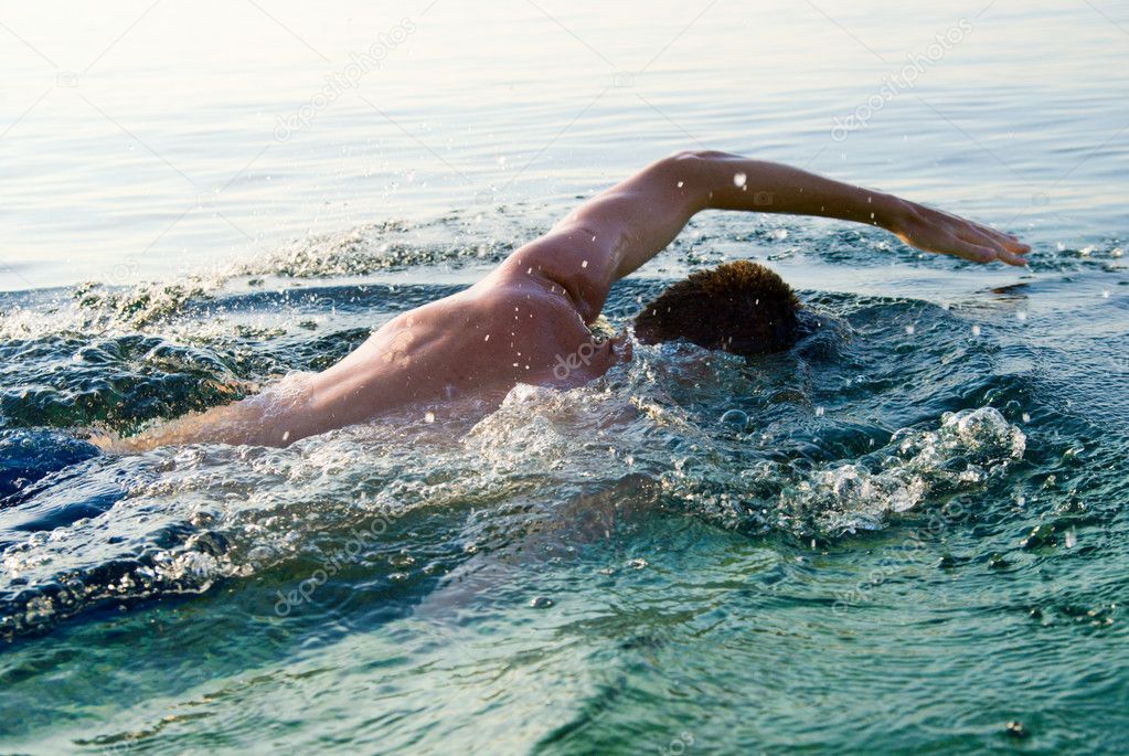 swimming man in clean ocean water