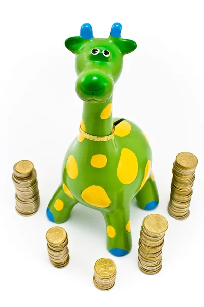 stock image Giraffe money-box surrounded by towers of the coines