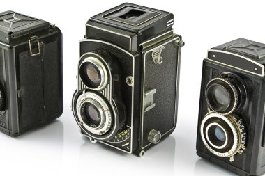 Three Vintage two lens photo cameras isolated on white clipart