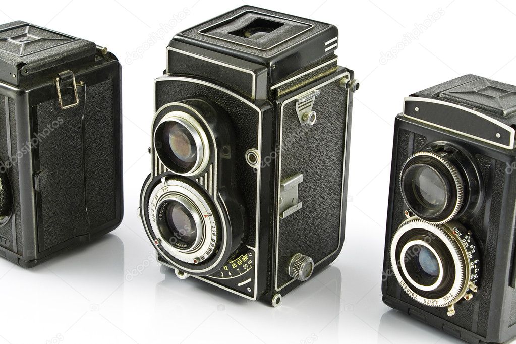 Three Vintage two lens photo cameras isolated on white