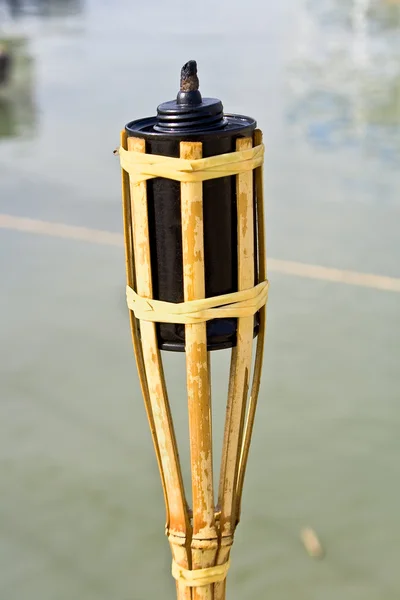 Bamboo torche near water — Stock Photo, Image