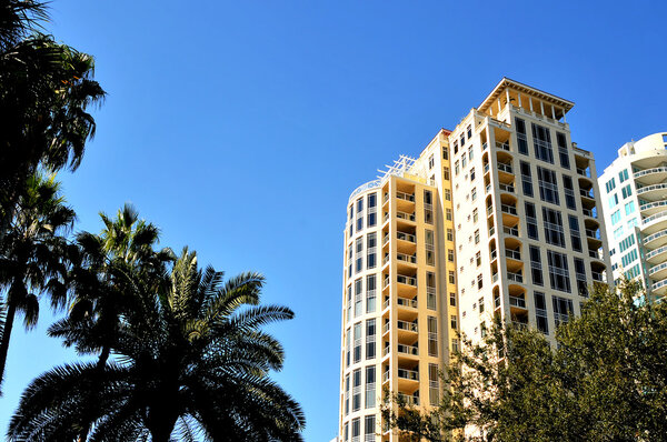 Picturesque view of a downtown building with palm trees blowing in the gentle breeze located in the waterfront district, St. Petersburg, Florida.