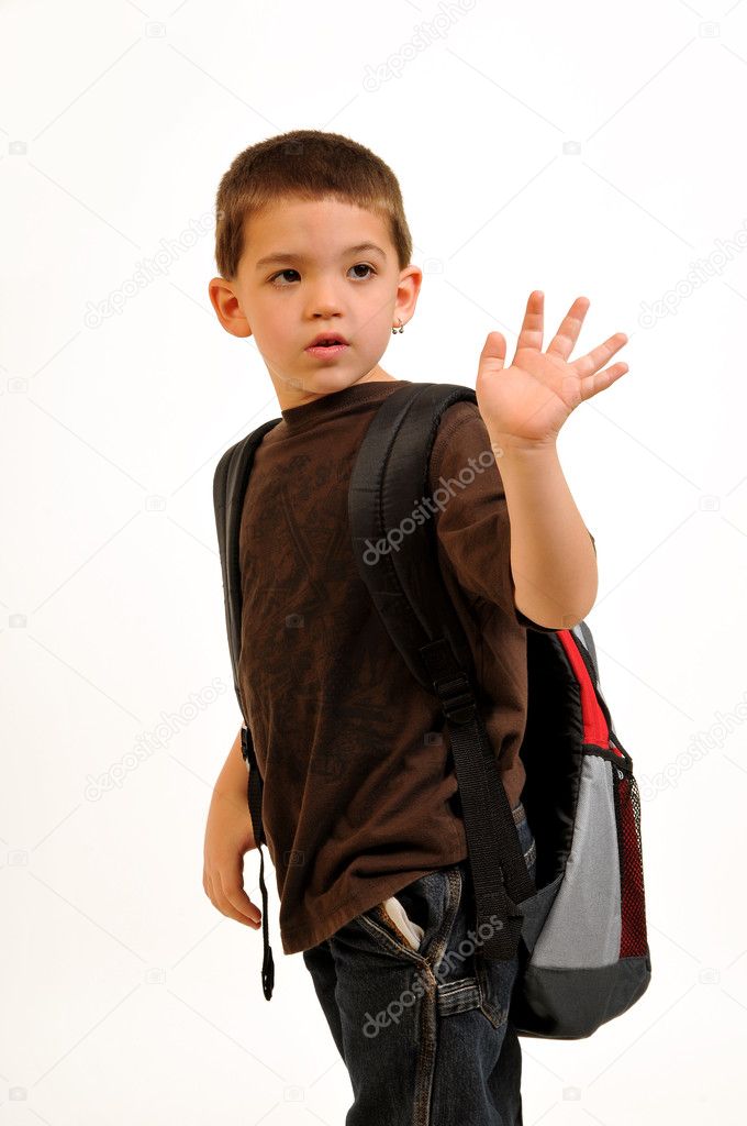 Boy, turning back and waving goodbye heading off to school.