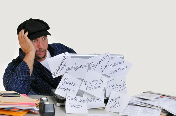 Overwhelmed man dealing with finances — Stock Photo, Image