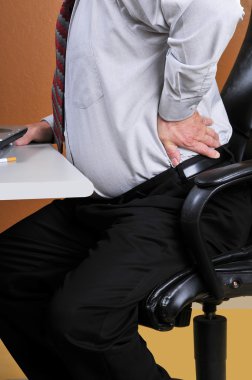 Back pain while working at the office clipart
