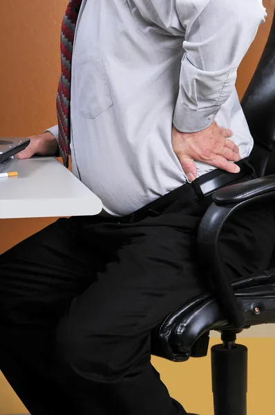 Back pain while working at the office — Stock Photo, Image