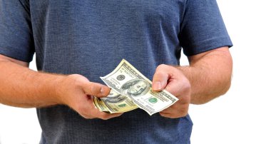 Man in casual clothing handing money as if he is paying for something. clipart