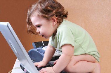 Baby riveted to the laptop screen clipart