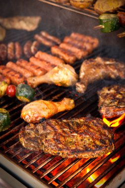 Steak and other Meat on a BBQ clipart