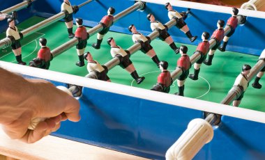 Hand on an old tabletop Soccer Game clipart