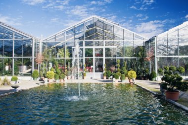 Big Greenhouse with Fountain and some clouds clipart