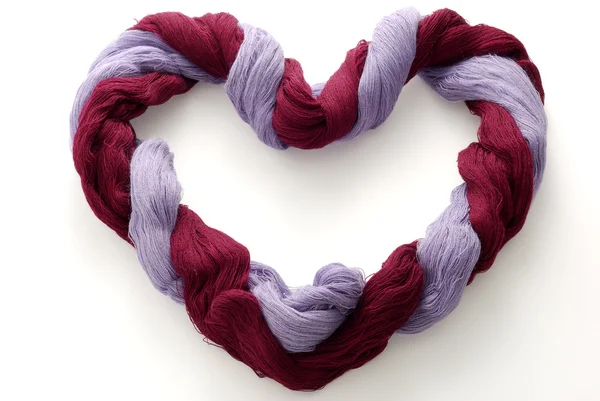 Bicolored skein of wool in shape of heart — Stock Photo, Image
