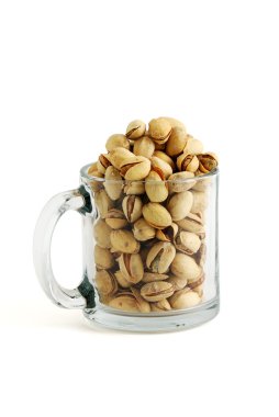 Low glass beer mug filled with salted pistachios isolated on white background clipart